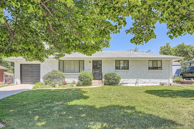 366 Kenton St, Aurora, CO 80010 - view of front of home featuring brick siding, a front lawn, and a shingled roof