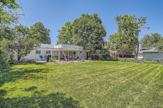366 Kenton St, Aurora, CO 80010 - view of grassy yard featuring a patio
