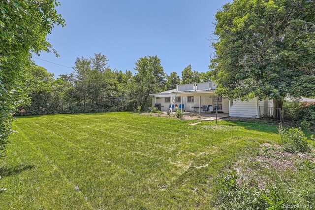 366 Kenton St, Aurora, CO 80010 - view of grassy yard featuring a patio
