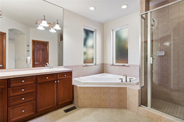 bathroom featuring independent shower and bath and vanity