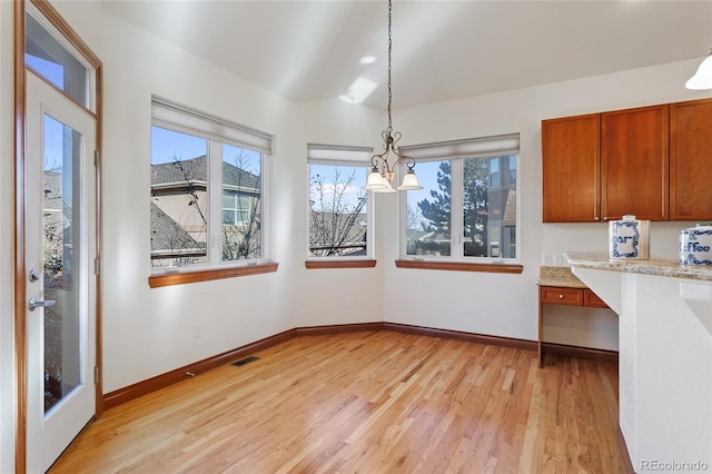 unfurnished dining area featuring light hardwood / wood-style flooring