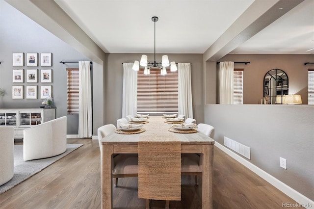 13463 Tamarac Pl, Thornton, CO 80602 - dining space featuring a chandelier and wood finished floors