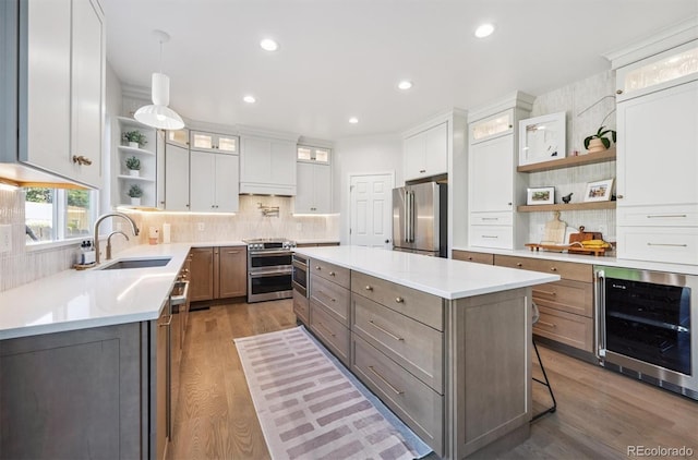 13463 Tamarac Pl, Thornton, CO 80602 - kitchen with wine cooler, open shelves, appliances with stainless steel finishes, a kitchen island, and wood finished floors