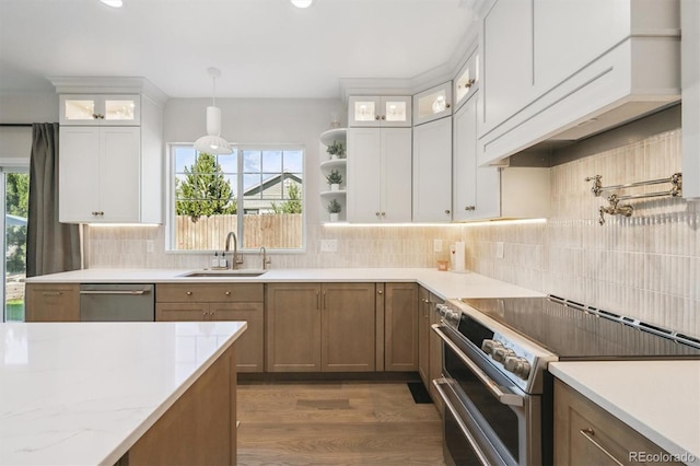 13463 Tamarac Pl, Thornton, CO 80602 - kitchen featuring appliances with stainless steel finishes, wood finished floors, white cabinets, backsplash, and recessed lighting