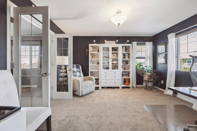 13463 Tamarac Pl, Thornton, CO 80602 - living area with healthy amount of natural light, carpet floors, and french doors