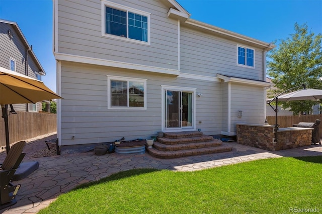 13463 Tamarac Pl, Thornton, CO 80602 - rear view of house with entry steps and a patio