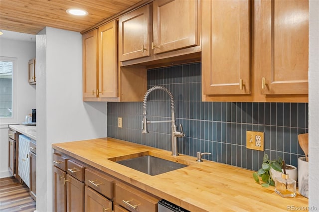 kitchen featuring wood ceiling, butcher block countertops, a sink, and tasteful backsplash