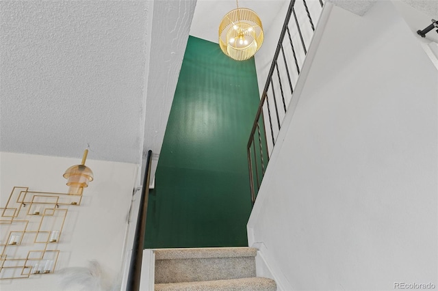 staircase with a textured ceiling