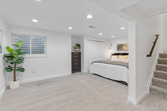 carpeted bedroom with recessed lighting, baseboards, visible vents, and a closet