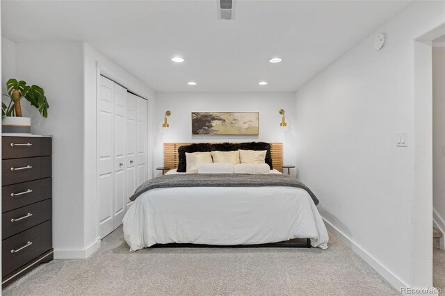 bedroom with baseboards, visible vents, and light colored carpet