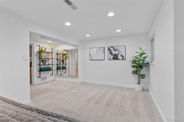 interior space with baseboards, carpet, recessed lighting, and visible vents