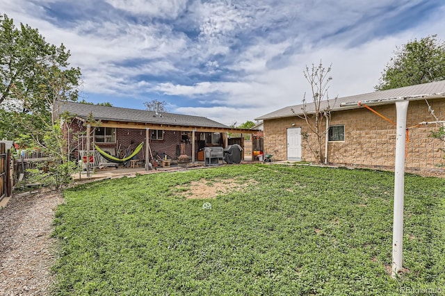 rear view of house featuring a patio area and metal roof