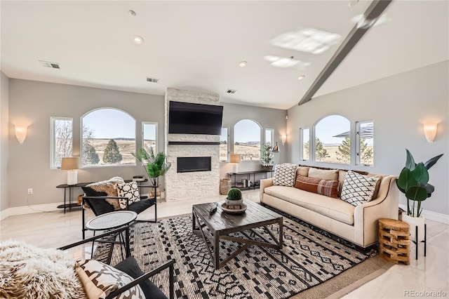 living room featuring a stone fireplace and lofted ceiling