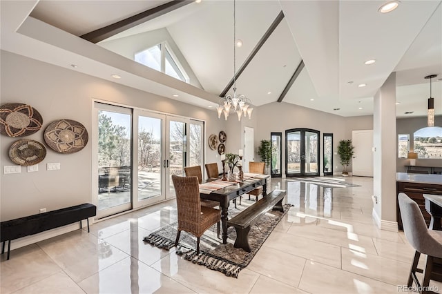 dining space featuring an inviting chandelier, high vaulted ceiling, and french doors