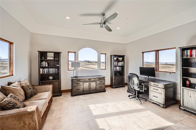 office with a healthy amount of sunlight, light tile patterned floors, and ceiling fan