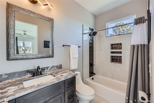 full bathroom featuring shower / tub combo with curtain, vanity, toilet, and ceiling fan