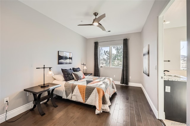 bedroom with dark hardwood / wood-style flooring and ceiling fan