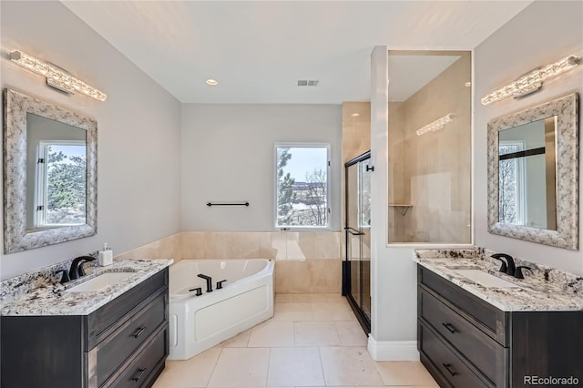 bathroom featuring tile patterned flooring, vanity, plenty of natural light, and plus walk in shower