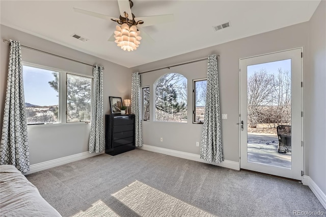 doorway featuring ceiling fan, light colored carpet, and a wealth of natural light