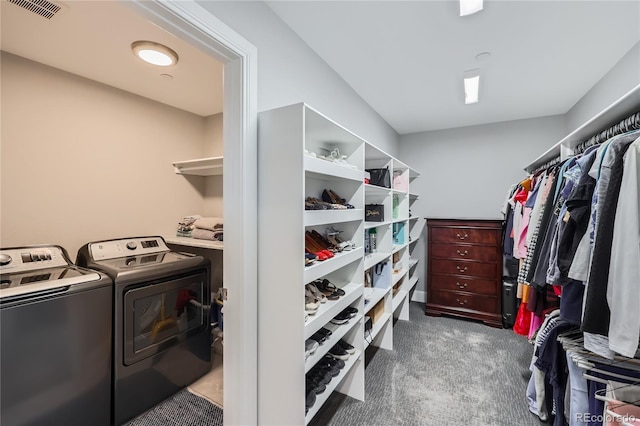 spacious closet featuring washing machine and dryer and carpet