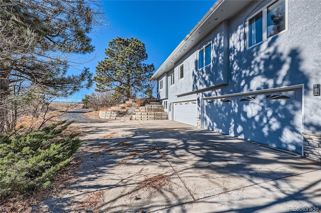 view of side of home featuring a garage