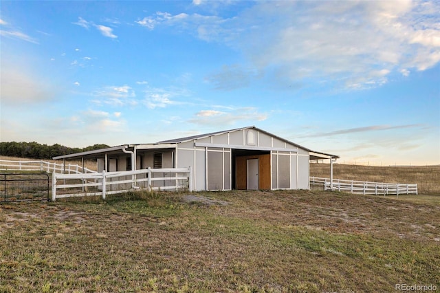 view of stable with a rural view