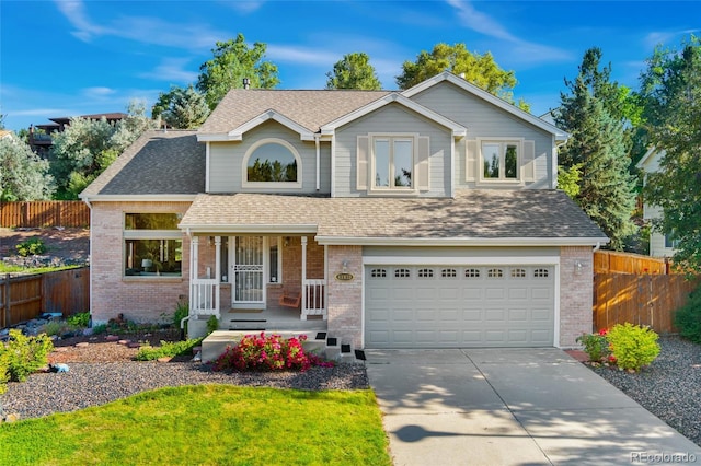 11932 W 56th Cir, Arvada, CO 80002 - traditional-style house featuring a garage, brick siding, covered porch, and driveway