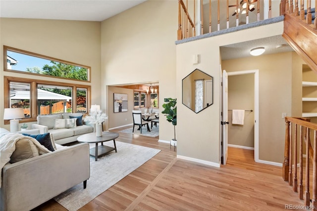 11932 W 56th Cir, Arvada, CO 80002 - living room with high vaulted ceiling and light wood-style floors