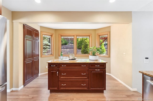 11932 W 56th Cir, Arvada, CO 80002 - kitchen featuring stainless steel appliances, light wood-type flooring, light stone countertops, and recessed lighting