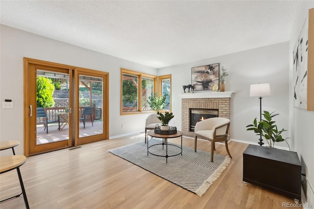 11932 W 56th Cir, Arvada, CO 80002 - living area with a brick fireplace and wood finished floors