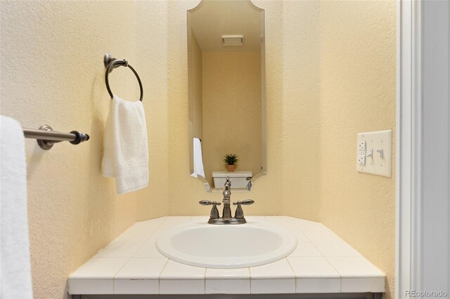 11932 W 56th Cir, Arvada, CO 80002 - bathroom with vanity and a textured wall