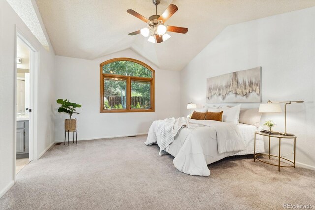 11932 W 56th Cir, Arvada, CO 80002 - carpeted bedroom with vaulted ceiling, ensuite bath, and a ceiling fan