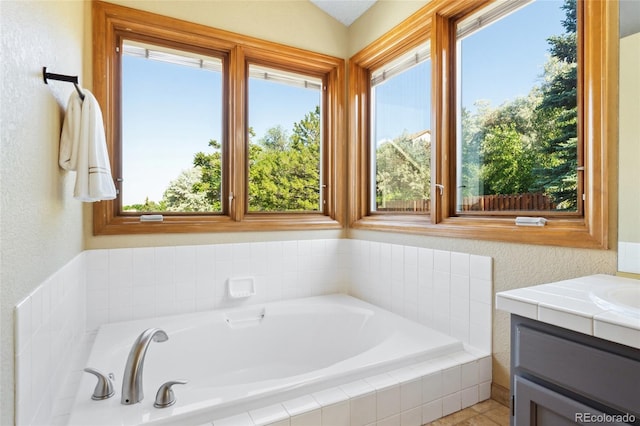 11932 W 56th Cir, Arvada, CO 80002 - full bathroom featuring a textured wall, a garden tub, and vanity