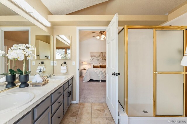 11932 W 56th Cir, Arvada, CO 80002 - ensuite bathroom with double vanity, a shower stall, tile patterned flooring, a ceiling fan, and a textured ceiling