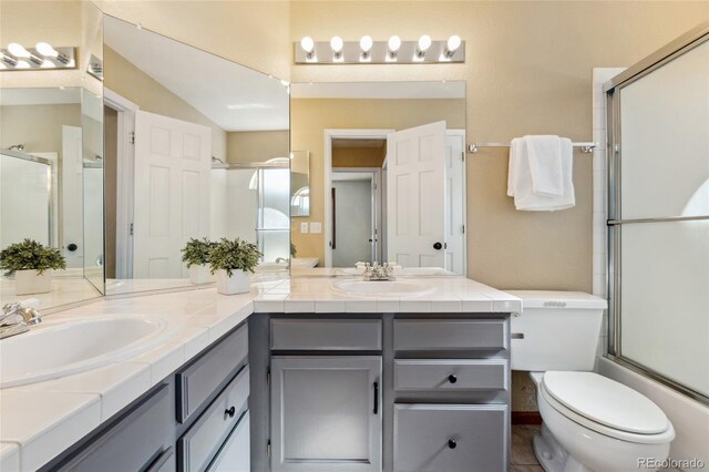 11932 W 56th Cir, Arvada, CO 80002 - bathroom featuring double vanity and toilet