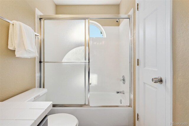 11932 W 56th Cir, Arvada, CO 80002 - full bath with a textured wall, enclosed tub / shower combo, and vanity