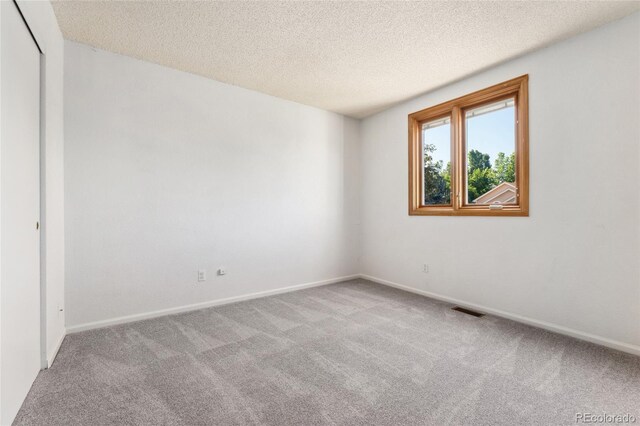 11932 W 56th Cir, Arvada, CO 80002 - spare room with carpet floors and a textured ceiling