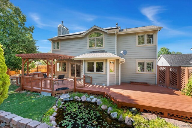 11932 W 56th Cir, Arvada, CO 80002 - back of house with a pergola, a chimney, a deck, and roof with shingles