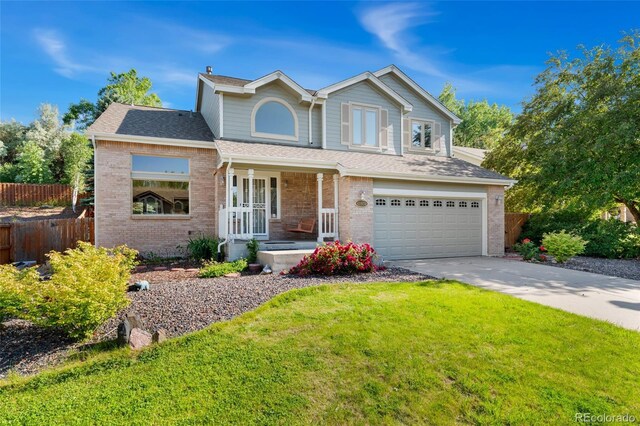 11932 W 56th Cir, Arvada, CO 80002 - traditional-style house with covered porch, a garage, brick siding, and concrete driveway