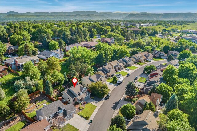 11932 W 56th Cir, Arvada, CO 80002 - aerial view of property and surrounding area featuring a mountain backdrop and nearby suburban area