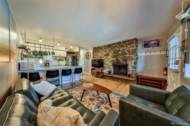 466 Hi Country Dr Unit 109, Winter Park, CO 80482 - living room featuring light wood-style floors and a fireplace