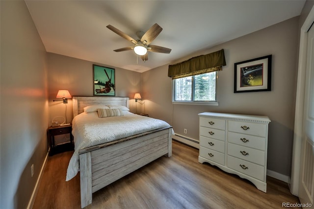 466 Hi Country Dr Unit 109, Winter Park, CO 80482 - bedroom with a baseboard heating unit, wood finished floors, and a ceiling fan