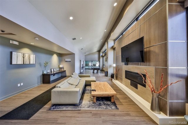 466 Hi Country Dr Unit 109, Winter Park, CO 80482 - living room featuring lofted ceiling, a glass covered fireplace, light wood-style flooring, and recessed lighting