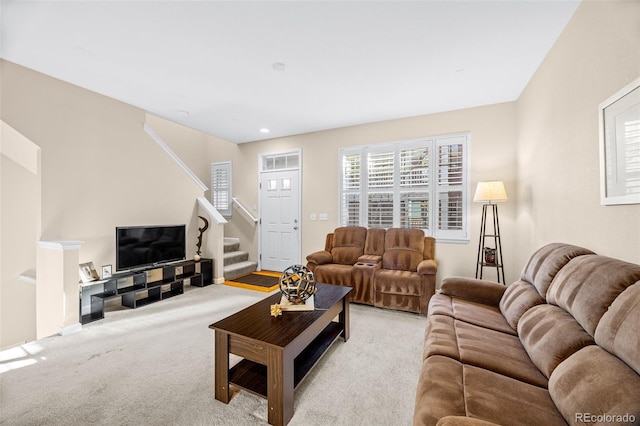 living room featuring light carpet, stairway, and recessed lighting