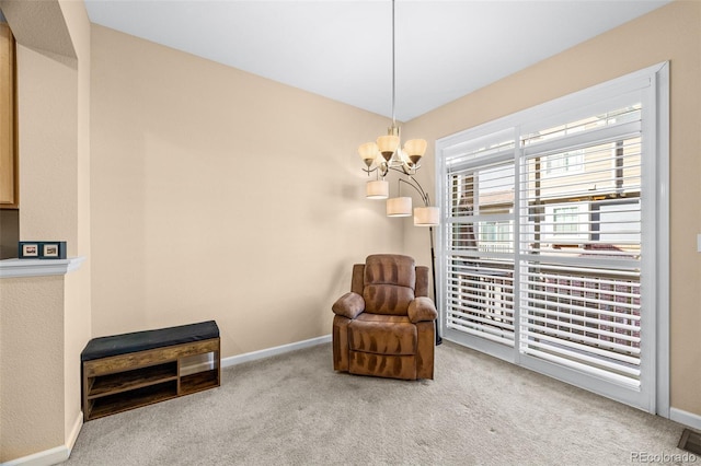 living area with carpet floors, baseboards, and a chandelier