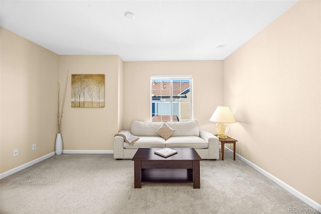 living area featuring baseboards and carpet flooring