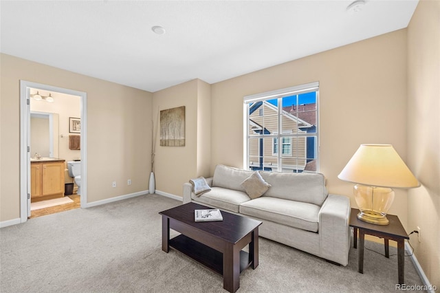 living room featuring light carpet and baseboards