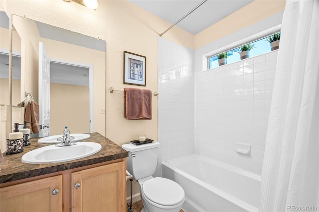 full bathroom featuring shower / bath combination with curtain, vanity, and toilet