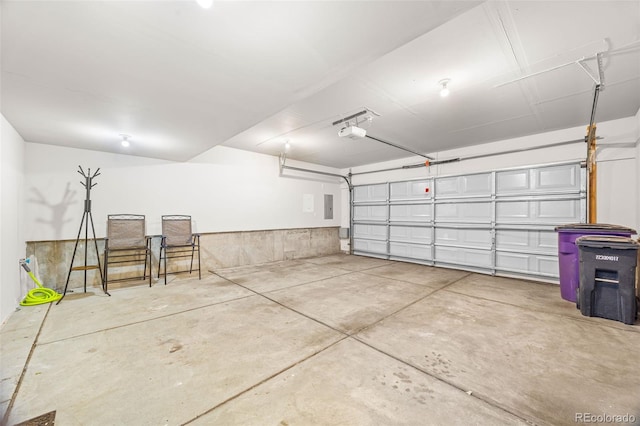 garage featuring electric panel and a garage door opener