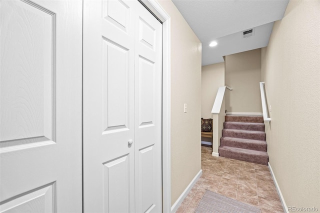 staircase featuring recessed lighting, baseboards, visible vents, and tile patterned floors